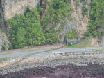 Rail tracks displaced onto the road and rocks on the Kaikoura coast. Photo: @NZDefenceForce on Twitter.