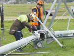 A Rainer Irrigation crew led by foreman Wame Ramalasou, left, works on an upturned pivot near Staveley in Mid-Canterbury. Their first task was to lift a section off a track to give the farmer full use of the farm again, before lifting it all back onto its wheels and assessing the full extent of the damage. Photo Credit: Nigel Malthus.