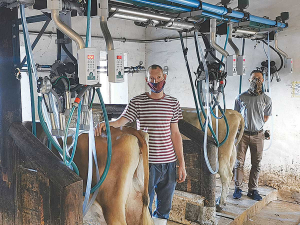 Camphill Village staff member Louis Nel (left) with Alon Lipman from GEA inside the upgraded dairy parlour, including GEA Classic 300 milking clusters.