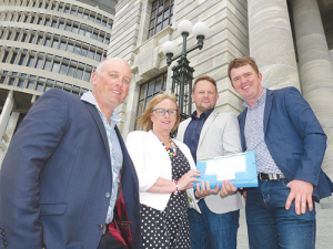 Migrant petitioners (from left) Chris Lewis, Barbara Kuriger, Ben De’Ath and Wayne Langford on the steps of Parliament with the petition.