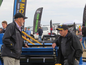 Founding director Bill McIntosh (right) at McIntosh Farm Machinery&#039;s Fieldays site solving the world&#039;s problems with Brian Hight.