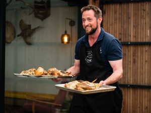 Rabobank agribusiness manager Tom Fleetwood helps with the table service during the episode featuring Michael Van de Elzen