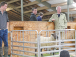 Is that a hint of a smile? Blair Gallagher and his son Hamish (far left) look on as the bidding for Lot 19 heads to $15,000, thought to be a NZ record for a crossbred ram lamb. 