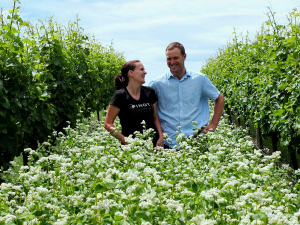 Jason and Anna Flowerday in a field of buckwheat.
