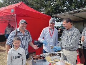 Ruralco Chair, Sir David Carter (centre) and CEO, Tony Aitken (right) meeting with locals (from left), Rico and Colin Weaver at this year’s Mayfield A &amp; P Show.