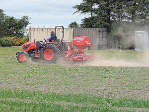 A mechanical spring-tine weeder is towed through a young trial crop during the recent FAR CROPS Expo.